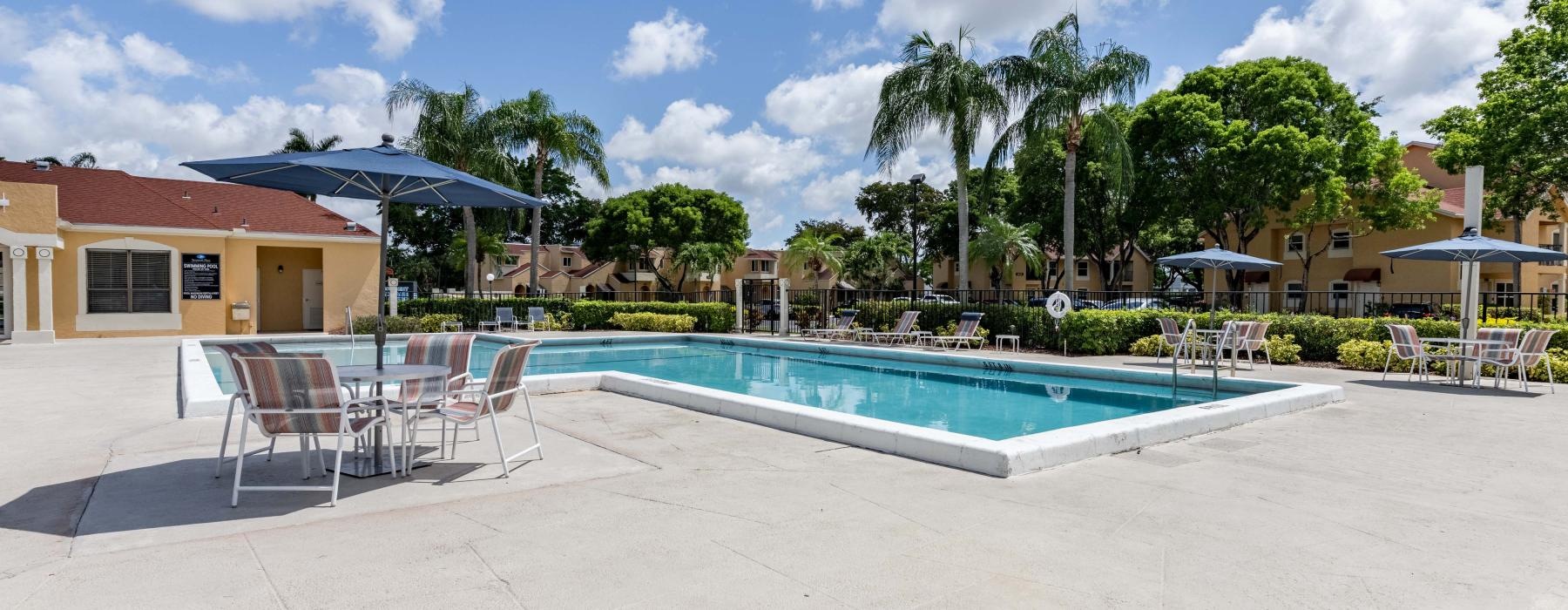 a pool with chairs around it
