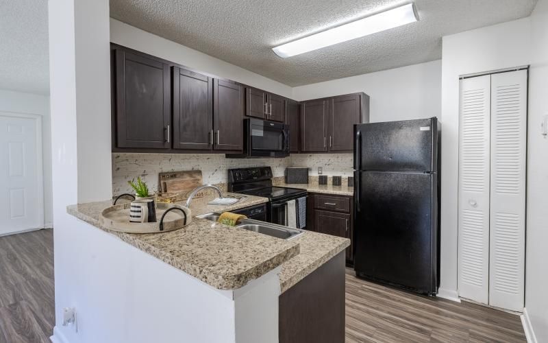 a kitchen with black appliances